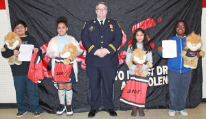 Four DARE essay contest finalists with the Greenbelt Police Chief.  From left, Jonathan Abarca, Armani Hargrove, Chief Tom Kemp, Dana Mazariegos and Braylon Martin.  Photo courtesy of the Greenbelt Police Department
