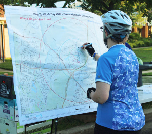 Cyclist traces her route on the interactive map.  Photo by Julie Magness