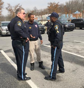 Acting Chief Thomas Kemp (left) confers with a county officer (center) and Cpl. Johnnie Guy.