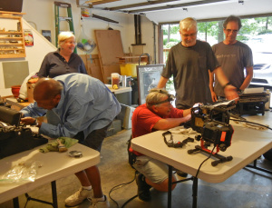 Volunteers (L to R) Margaret and Tom Morris, Steve Skolnik, Jerry Bonnell and Ray Zammuto (Lisa Zammuto not pictured) tussle with sticky keys and balky platens. Photo by Cathie Meetre
