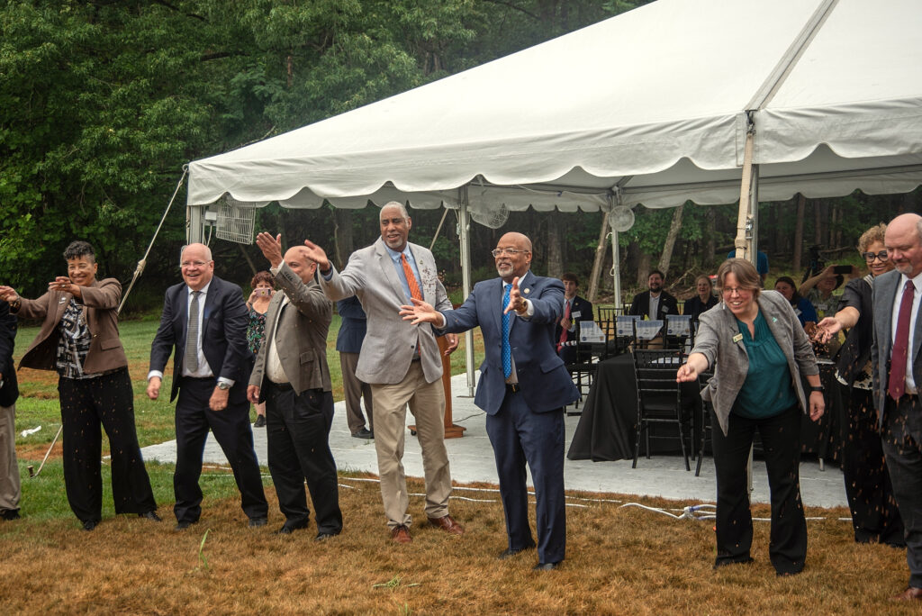 Dignitaries throw milkweed seeds